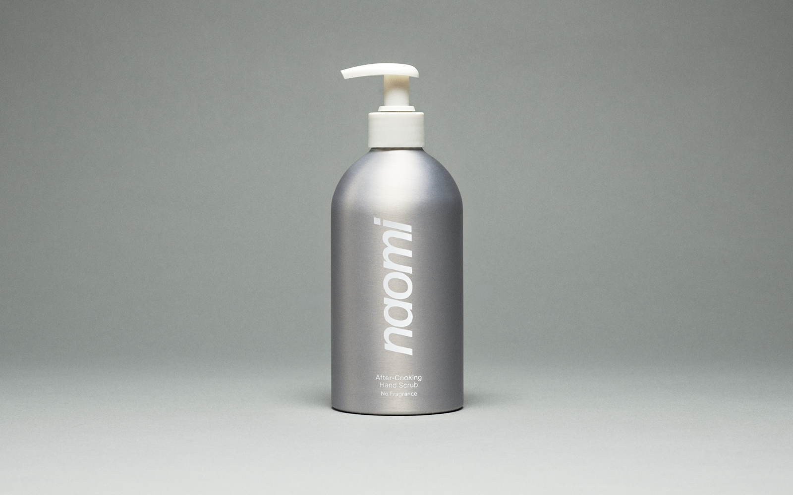 A bottle of amber-colored Naomi hand wash labeled 'Los Angeles Terroir' against a plain grey background.