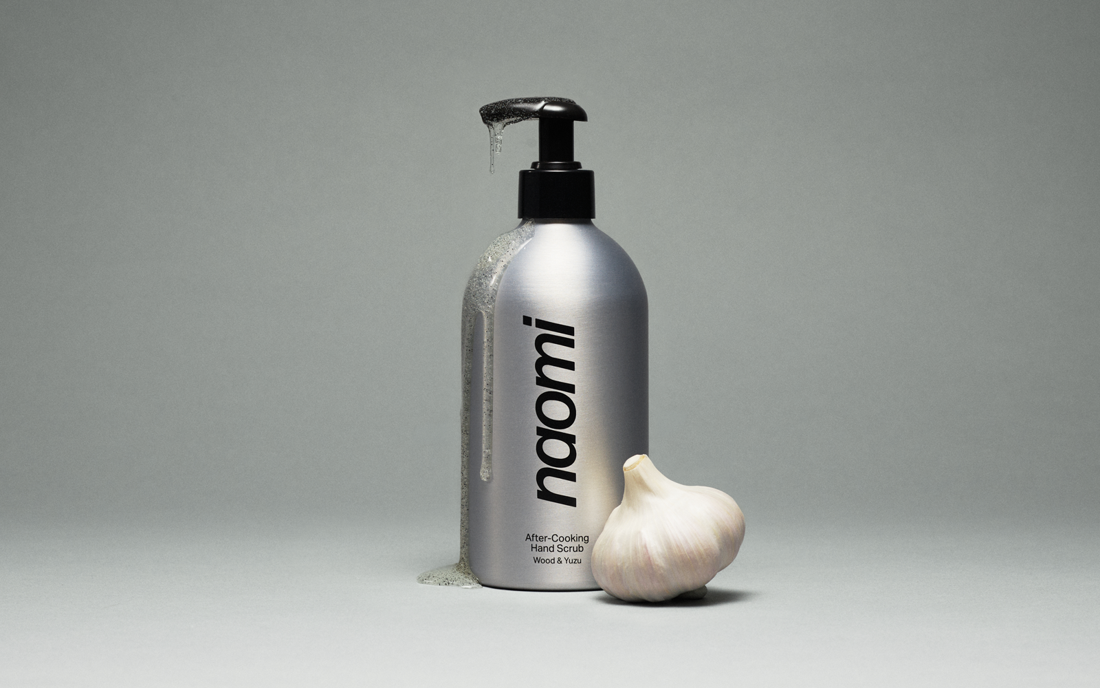 A bottle of amber-colored Naomi hand wash labeled 'Los Angeles Terroir' against a plain grey background.