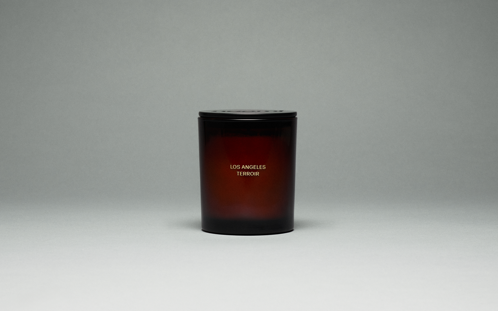 A bottle of amber-colored Naomi hand wash labeled 'Los Angeles Terroir' against a plain grey background.